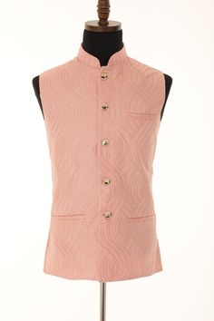 A Self embellished textured blend fabric gives our signature Nehru jacket an occasion-ready update. Cut slim with a Mandarin collar and pockets, it's fully lined and is finished with gold buttons. Pair with any contrast trousers for an instant stylish wedding or party outfit. Specifications Color - Peach Sleeve Length - Sleeveless Lined with Polyester and rayon lining Jacket Length depends on sizes Top Shape - Straight Top Hemline - Straight Neck - Mandarin Collar Jacket Pattern - Self embellished textured blend fabric  Size 36 to 46 Available WASH CARE INSTRUCTIONS - Please dry clean only when it is applicable. Slight variation in color is possible due to digital photography. Mandarin Collar Jacket, Indian Party, Indian Party Wear, Nehru Jackets, Sleeveless Jacket, Thread Work, Jacket Pattern, Stylish Wedding, Wedding Wear