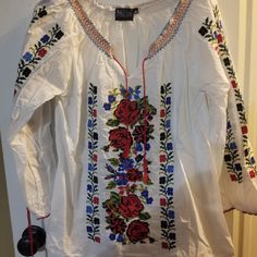 Never Worn Peasant Blouse With Floral Embroidery On Front And On Sleeves As Well As Around Collar Bohemian Peasant Top With Multicolor Embroidered Neckline, Spring Folk Embroidered Peasant Top, Traditional Embroidered V-neck Peasant Top, Spring Multicolor Embroidered Peasant Top, Spring Folk Peasant Tunic Top, Spring Folk Tunic Peasant Top, Spring Folk Style Peasant Tunic Top, Bohemian Embroidered Peasant Tunic Top, Peasant Style Embroidered Top For Vacation