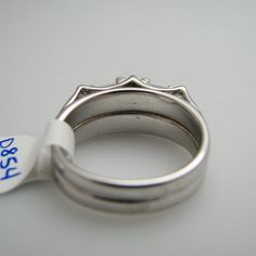 two wedding rings with a tag attached to them