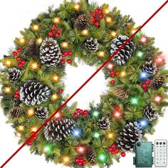 a christmas wreath with lights and pine cones