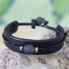 Men's African Leather Wristband Bracelet - Black Standout | NOVICA Handmade Adjustable Spiritual Leather Bracelet, Adjustable Hand Wrapped Spiritual Leather Bracelet, Artisan Hand Wrapped Black Bracelets, Artisan Hand Wrapped Black Bracelet, Artisan Hand-wrapped Black Bracelet, Adjustable Black Leather Bracelets, Minimalist Adjustable Leather Wristband, Adjustable Minimalist Leather Wristband, Adjustable Modern Black Wristband