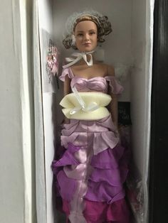 a barbie doll dressed in a purple and white dress