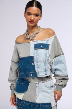 This denim moment lives in our minds rent free. The AKIRA Label Denim Dreams Zipper Detail Sweatshirt is made from a cotton blend base that consists of denim and knit patchwork fabrications. This trendy piece features an off the shoulder design, long sleeves with zipper accents and ribbed knit cuffs, and a cropped, boxy fit. Complete with faux button accents, a mock flap pocket, and a pull-on fit. Finish off the fit with the coordinating bottoms, The AKIRA Label Denim Dreams Maxi Skirt.  - Main: 65% Cotton 35% Polyester, Trim: 75% Cotton 23% Polyester 2% Spandex - Hand Wash Cold - Super Stretchy - Imported (all measurements are approximate from size small) - 16” Shoulder to Hem - 21” Sleeves - Model is 5'10" Product ID: 363014 (all measurements are approximate from size 1X) - 19” Shoulder Denim Blue Patchwork Top For Fall, Fall Denim Blue Patchwork Denim Top, Fall Denim Blue Patchwork Top, Denim Blue Patchwork Denim Top, Casual Patchwork Denim Top For Fall, Medium Wash Denim Patchwork Top, Trendy Denim Blue Patchwork Top, Blue Cotton Denim Top With Patchwork, Blue Cotton Patchwork Denim Top