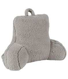 a gray stuffed animal pillow sitting on top of a white floor next to it's head