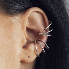 Detailed Description: Up your ear game with these super cool modern sterling silver ear cuffs, an ingenious way to achieve that wow factor - no piercings needed!For that bold fashion-forward look simply just slip the cuff over the side of the ear and then gently pinch to secure, can also be worn on different parts of the ear.One is never enough! Why not stack these single ear cuff earrings to give your ear that edge, have a browse through the various images to get inspired and start the ball rolling on creating your unique look.Size Option - these ear cuffs are available in 2 sizes:Small Cuff (see images 1 & 3)Large Cuff (see image 2 & 3) In this range - Nest Gold Stud Earrings, Silver and Gold Disk Stud Earrings, Tear Drop Gold Ear Jacket Made from: Made from Sterling Silver. Dimensions: Silver Ear Cuffs, Ear Cuff Piercing, Gold Ear Jacket, Ear Parts, Conch Earring, Ear Climber, Ear Ring, Fake Piercing, Silver Ear Cuff