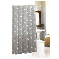 a bathroom with a shower curtain that has dogs and cats on it in grey colors