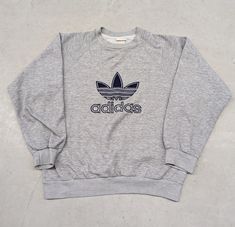 Vintage 80s Adidas essential logo script sweater Size: M Tag: Adidas Light signs of aging/wear on collar but overall in great condition Measurements are taken in the photos  Message for additional information on the piece or preferred shipping prices  All items ship within 1-3 business days of purchase  Items are preowned unless otherwise stated  Always happy to do discounts on bundles! Happy hunting!! Adidas Pullover, Adidas Sweater, Vintage Jumper, 80s Sweater, Pullover Sweater Men, Adidas Tops, Grey Adidas, Vintage Adidas, Pullover Men