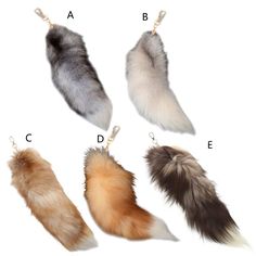 four different types of furs hanging from keychains on white background with letters in upper right corner