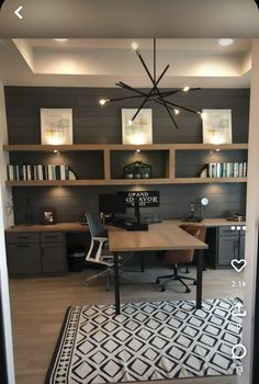 a home office with built - in shelving and lighting