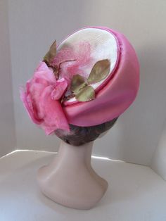 "SALE! 10% OFF! Striking Mid Century Hat in Peony Pink Chiffon. We will call this a modified bubble style, as it soars at front, but flattens at the back. Marche Exclusive designed this in a union shop. The peony pink chiffon covers white millinery straw. At the back of the crown poses the 6\" pink rose. Net covers all. See condition report below. In mid century style, this would be worn toward the top of the head, not at the forehead Size: 4 1/2\" tall at front to 1/2\" at the back; 6 1/4\" acr Fitted Pink Brimmed Cloche Hat, Pink Brimmed Hat For Church, Spring Pink Bonnet, One Size Fits Most, Pink Bonnet For Spring, One Size Fits Most, Retro Pink Wide Brim Hat, Pink Spring Bonnet Cap, Pink Bonnet For Spring, Retro Pink Brimmed Hat, Pink Spring Bonnet With Curved Brim