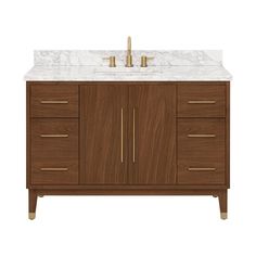 a bathroom vanity with marble top and two gold faucets