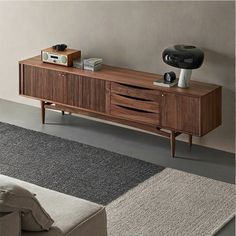 a living room with a couch and a tv on top of a wooden entertainment center