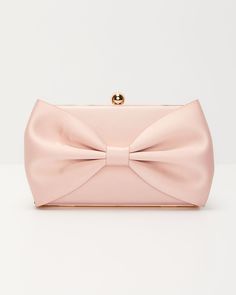 Indulge in a touch of Parisian romance with the Ma Chérie Satin Bow Clutch. This elegant accessory crafted from luxurious satin fabric, features a stunning bow accent at the front, adding a whimsical yet sophisticated flair. The top clasp closure ensures your essentials are secure while maintaining a sleek silhouette. Whether you’re attending a glamorous soirée or a romantic dinner, the Ma Chérie Satin Bow Clutch elevates any outfit with its classic allure. FINAL SALE Material: Polyester Top clasp closure Chain link shoulder strap Bow accent at front Satin fabric Dimensions: 8.5” L x 1.25” W x 4.75” H Luxury Satin Bow For Evening, Luxury Satin Bow For Party, Chic Evening Bow With Detachable Feature, Chic Satin Bow With Ribbon Details, Chic Satin Bow With Ribbon, Chic Satin Bow For Party, Chic Satin Bow For Formal Occasions, Luxury Detachable Bow For Evening, Silk Evening Bow With Decorative Detail