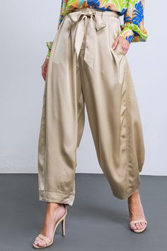 A solid woven satin pant featuring front closure, front pleats, side and back pockets, self sash tie, elasticized back waistband and tapered bottom. Crafted from luxurious woven satin, these POWERFUL CHARM WOVEN SATIN PANTS are perfect for any special occasion. A sash tie extends from a front pleat to a tapered bottom, providing a superbly tailored silhouette. Side and back pockets provide functional utility, while the elasticized back waistband ensures maximum comfort. Elevate any look with the Satin Cargo Pants, Satin Pant, Silky Pants, Satin Pants, Christmas Outfits, Bridal Fashion, Matching Top, Indian Bridal, Ethiopia