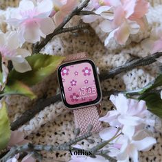 an apple watch with pink flowers on it