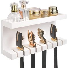 a white shelf with gold and black items on it