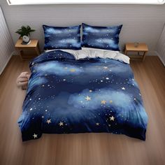 a bed covered in blue and white sheets with stars on the comforter, next to a night sky