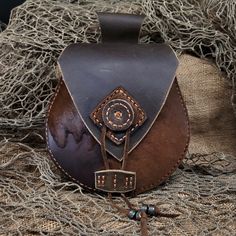 "Discover \"Ravens of Floki\" Leather Bags - a fusion of Nordic and Renaissance style, perfect for Medieval, Renaissance festivals, Burning Man, and rodeos. **Functional Elegance Handmade with love, these bags effortlessly slide onto your belt (upto a 3 inch belt) for style and convenience. **Limited Availability Rich brown Buffalo hides with acid-washed skins - each one unique. **Handmade, Hand-Stitched Crafted stitch by stitch, a testament to our dedication to quality. Elevate your style with Handmade Leather Belt Bag For Larp, Medieval Leather Pouch For Larp, Handmade Medieval Pouch For Larp, Buffalo Style, Medicine Bag, Leather Belt Bag, Belt Bags, Hip Bag, Carrier Bag