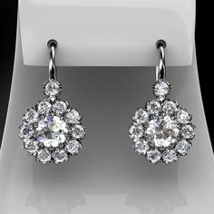 Women's drop/dangle earrings containing 2 forever brilliant moissanite center stones and 22  natural brilliant cut diamonds.EARRINGS DESCRIPTION Style # KE-3105Material - 14K , 18K White Gold/ 14K, 18K Yellow Gold/ 14K, 18K Rose Gold/ Platinum-price upon request.Moissanite cut- roundMoissanite size -  approx. 5.0x5.0mm Diamonds cut - roundDiamonds Color- approx G/HClarity approx - VS2/SI1Diamonds weight - approx 0.86 carat total weight for both earrings.You can find ring measurements on the blue Antique Style Jewelry, Diamond Cluster Earrings, Jewelry Appraisal, Detailed Jewelry, Peoples Jewellers, Saree Trends, Earrings In Gold, Round Moissanite, Custom Earrings