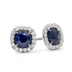 The perfect combination! Round blue sapphires surrounded by sparkling white diamond halo earring settings make a subtle statement. Versatile and unique these earrings are perfect for every day wear or special occasions.  Each sapphire measures 4mm and is surrounded by a halo of 36 pave set diamonds. Blue Halo Cubic Zirconia Earrings, Elegant Blue Gia Certified Diamond Earrings, Blue Sapphire Diamond Earrings With Brilliant Cut, Sapphire Earrings With Halo Setting For Anniversary, Blue Diamond Earrings With Halo Design For Anniversary, Gia Certified Sapphire Diamond Earrings, Blue Halo Setting Earrings For Formal Occasions, Blue Halo Setting Earrings For Formal Events, Formal Blue Halo Setting Earrings