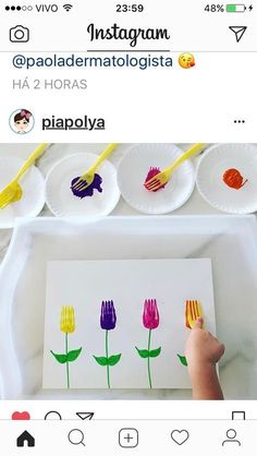 someone is painting flowers on paper plates with watercolors and then they are colored