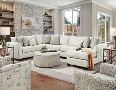 a living room filled with lots of white furniture