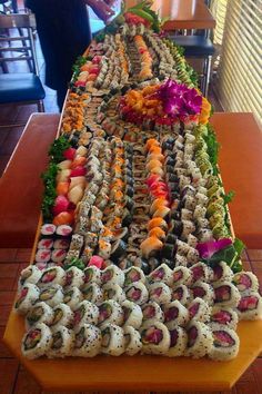 a long table covered in lots of sushi