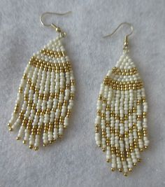 These fringe style earrings are handmade by me, Janet J. Griffen...  They are made with #11 glass seed beads...  The colors are white and gold glass seed beads and beaded with Nymo thread... Measurements of the earrings are 3 3/4 inches long by 1 inch wide and the ear hooks are of gold tone... Any questions, please e-mail me.... White Southwestern Beaded Earrings, Southwestern Style White Jewelry With Dangling Beads, Southwestern Style White Earrings For Festivals, White Beaded Fringe Jewelry For Crafting, Traditional White Earrings With Gold Beads, Artisan White Fringe Jewelry, Fringe Round Beads For Diy Jewelry Making, Artisan White Earrings With Beaded Fringe, Southwestern Style White Beaded Dangle Earrings