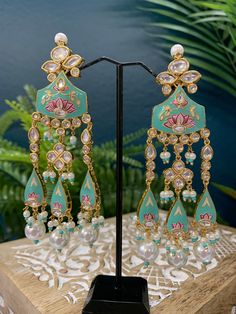 Hand painted meena jhumki style earring. Stone work and crystal bead work. Back and front side gold plated so long lasting color. Light weight and brass made. Silver foil Kundan. Turquoise Kundan Chandbali Earrings, Turquoise Kundan Earrings For Festivals, Turquoise Chandbali Earrings With Latkans, Turquoise Kundan Earrings For Wedding, Turquoise Meenakari Temple Jewelry Earrings, Turquoise Temple Jewelry Earrings For Festivals, Traditional Turquoise Danglers For Wedding, Festive Kundan Turquoise Earrings, Festive Turquoise Kundan Earrings