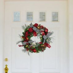 a christmas wreath is hanging on the front door