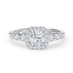 a diamond engagement ring with an oval center surrounded by round diamonds