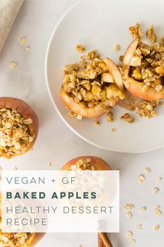 two baked apples on a plate with granola toppings and cinnamon sticks next to them