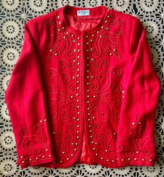 "Amazing, ruby red, embroidered bolero covered in gold studs and red rhinestones. Wonderfully, embellished blazer with gold, cone shaped studs along the neckline, waistline, sleeves, and pretty much all over. Cherry, red rhinestones add a touch of sparkle! In good vintage condition!! Normal vintage wear with some tiny holes. Tag Says: 8/fits like a S/M Label: Raffles Measurements taken while lying flat: Pit to pit: 18\" Shoulder to shoulder: 15 1/2\" Top to bottom: 23 1/2\"  Waist: 21\"  Sleeve Winter Embellished Long Sleeve Blazer, Fitted Winter Festive Blazer, Vintage Red Party Blazer, Spring Embellished Fitted Blazer, Christmas Formal Fitted Outerwear, Fitted Formal Christmas Outerwear, Fitted Formal Outerwear For Christmas, Fitted Red Embroidered Outerwear, Fitted Winter Outerwear With Gold Embroidery