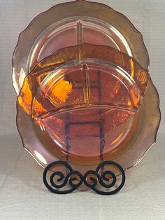 an orange glass plate sitting on top of a table