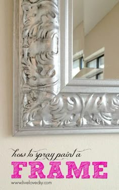 an ornate silver mirror hanging on the wall