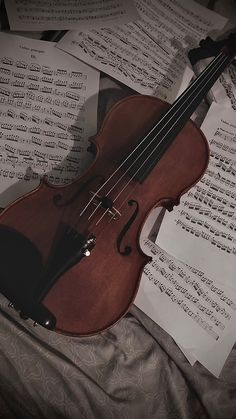 a violin laying on top of sheet music