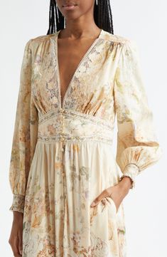 Signature crystals and ornate floral lace decorate this silk-enriched linen maxi dress featuring a gorgeous garden of soft-hued blooms entwined with golden fronds and leopard spots. Australian designer Camilla Franks often takes inspiration from far-flung destinations—case in point: this print pays tribute to the history and natural beauty of Egypt. 57" length (size Medium) Rouleau-button closure V-neck Long sleeves with shirred cuffs Unlined 82% linen, 18% silk Dry clean Imported Designer Cloth Elegant Long Sleeve Floral Embroidered Kaftan, Luxury Long Sleeve Floral Embroidered Kaftan, Elegant Floor-length Floral Embroidered Kaftan, Lace Trim Long Sleeve, Silk Kaftan With Floral Print And V-neck, Luxury V-neck Floral Embroidered Kaftan, Silk Maxi, Leopard Spots, Traditional Clothes