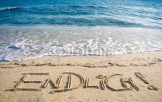 the word eagles written in the sand at the beach with waves coming in to shore