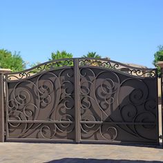 an iron gate with intricate designs on it