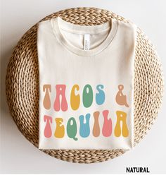 Tacos and Tequila Shirt, Unisex Cinco De Mayo Shirt, Fiesta Shirt, Tequila Shirt, Womens Cinco De Mayo Shirts, Margarita Shirt, Tequila Tee Looking for additional outdoor/vacation/warm weather apparel? Check these out: https://www.etsy.com/shop/TheGraphicPeach?ref=seller-platform-mcnav§ion_id=31675954 Our shop uses direct-to-garment printing to make our products. The design ink is sprayed on, then allowed to soak into the fibers of the garment. This process yields fine quality prints and a smooth finish on the garment. BELLA + CANVAS T SHIRT The Bella + Canvas 3001 t-shirt feels soft and light, with just the right amount of stretch. It's comfortable and the unisex cut is flattering for both men and women. We can't compliment this shirt enough - it's one of our crowd favorites. And it's sur Tacos And Tequila Shirt, Multicolor Crew Neck Shirt For Cinco De Mayo, Multicolor Letter Print Tops For Cinco De Mayo, Cinco De Mayo Funny Print Crew Neck Top, Cinco De Mayo Funny Print Cotton Tops, Cinco De Mayo Cotton Tops With Funny Print, White Graphic Print Tops For Cinco De Mayo, Cotton Tops With Funny Print For Cinco De Mayo, Casual Multicolor Shirt For Cinco De Mayo