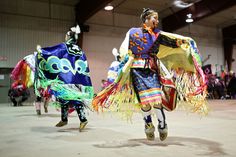 two women in colorful costumes are dancing