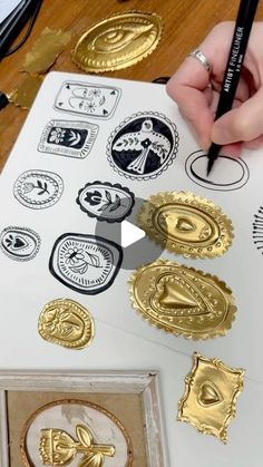 someone is making some gold stamping on paper