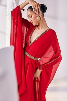 Red layered kaftan dress with an embroidered neckline. Paired with a scallop edged embellished belt. - Aza Fashions Bollywood Style V-neck Party Kaftan, Glamorous Dress With Dupatta For Eid, Glamorous Eid Dress With Dupatta, Party Georgette Maxi Kaftan, Party Georgette Kaftan In Maxi Length, Eid Party Dresses With Cape Sleeves, Anarkali Style Embellished Party Kaftan, Anarkali Embellished Kaftan For Party, Elegant Party Kaftan With Dupatta