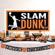 a table topped with food and drinks next to a sign that says slam dunk