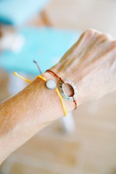 This is a Beach Sand slide knot bracelet. It is made with the white sand from the #1 beach in the US, Siesta Key Beach Florida This sand charm is a mini size for more of a petite looking bracelet.  This bracelet is on a yellow waxed polyester cording, the same as the pura vida bracelets. The charm is stainless steel. They give a great beachy look stacked with other cord bracelets! These bracelets looks amazing as a bikini accessory at the beach! It's light weight and easily adjusts to any size. Please see all my cording bracelets. I have many color combinations to choose from. Feel free to ask questions.  Thanks for looking! Live in an ocean state of mind... every single day. White Waxed Cord Beach Jewelry, Adjustable Strand Jewelry With Sliding Knot, Silver Minimalist Bracelets For The Beach, White Waxed Cord Jewelry For Beach, Minimalist Waxed Cord Jewelry For Beach, Adjustable Silver Jewelry For Vacation, White Waxed Cord Jewelry For The Beach, Beachy Bracelet With Sliding Knot, Adjustable Sand-colored Jewelry For Summer