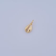 a yellow gold pendant with a tear shaped drop on it's end, against a white background