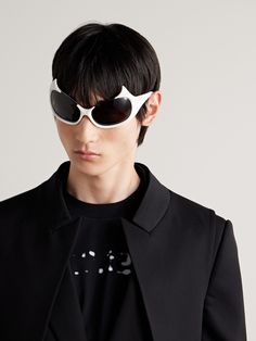 Balenciaga's 'Gotham' sunglasses are designed with peaks along the frames, inspired by the ears of the fictional city's infamous hero. Made from white acetate, they have an elongated oval shape and are fitted with dark lenses. Balenciaga Fashion, Eye Cover, Oval Frame, Sunglasses & Glasses, Gotham, Latest Fashion, Balenciaga, Fashion News, White And Black