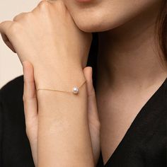 Are you a minimalist who loves dainty and simplistic designs? Then we have a bracelet that is just the right one for you. The Abby Single Pearl Bracelet is just what its name implies. The design features a big shiny pearl as the centerpiece. This single adornment is all the bracelet needs to deliver a powerful and highly elegant impact for you. - Rhodium and Gold plating over Sterling Silver- 1 Swarovski pearl, 6mm in diameter- Adjustable length of 5.5" to 6.5"- Available in Yellow Gold, White G Single Pearl Bracelet, Simplistic Jewelry, Pearl Bracelet Jewelry, Single Pearl, Bridesmaid Pearls, Wrist Wear, Gold Bracelet For Women, Handmade Wire Jewelry, Simplistic Design