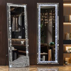 two large mirrors with lights on them in front of a room filled with furniture and decor