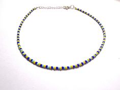 This super cute necklace is handmade with royal blue, baby blue, and yellow seed beads. It is a bestseller at my in person shows! It is perfect for summer, fall and all year round! Each necklace is made with additional extender chain, making it easily adjustable. Reach out with any questions! Blue Tiny Beads Choker For Summer, Yellow Tiny Beads Choker As Gift, Yellow Tiny Beads Choker For Gift, Blue Choker With Tiny Round Beads, Blue Choker With Tiny Beads, Adjustable Yellow Choker With Tiny Beads, Blue Tiny Beads Choker For Beach, Nebula Necklace, Summer Choker